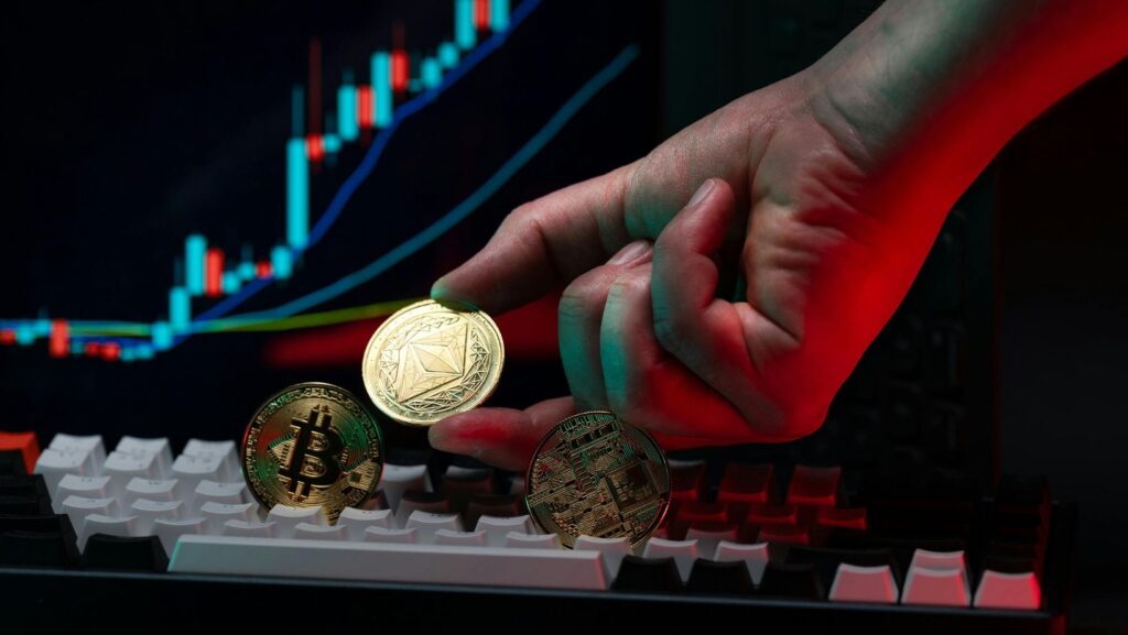 Hand Holding Cryptocurrency Coins with Graph Background